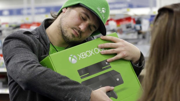 The X factor: a gamer hugs his new Xbox One.