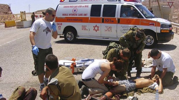 Shooting attack ... wounded Israeli soldiers are treated.