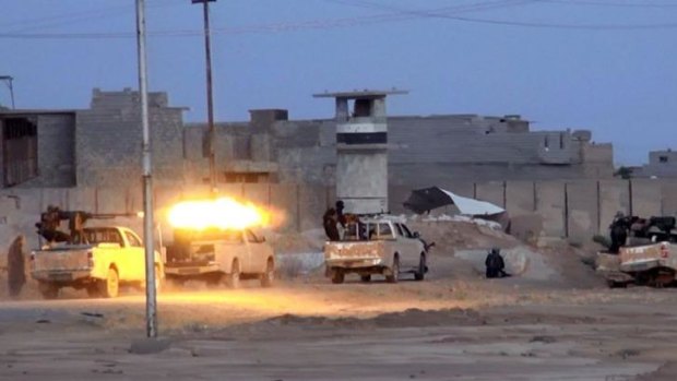 Islamic State of Iraq and the Levant fighters fire heavy machineguns in the northern Iraqi city of Samarra. 