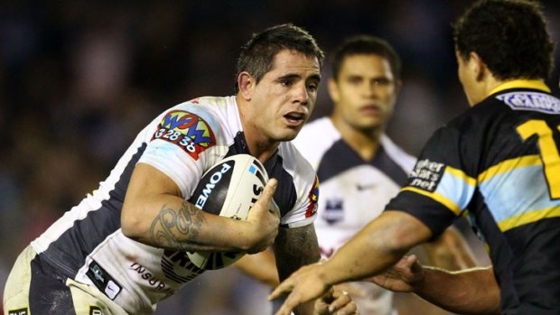 The Broncos' Corey Parker is tackled by the Sharks' defence.