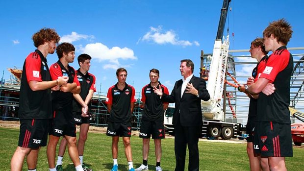 New beginning: Club chief executive Ian Robson shows Essendon's recruits the new training centre at Tullamarine.