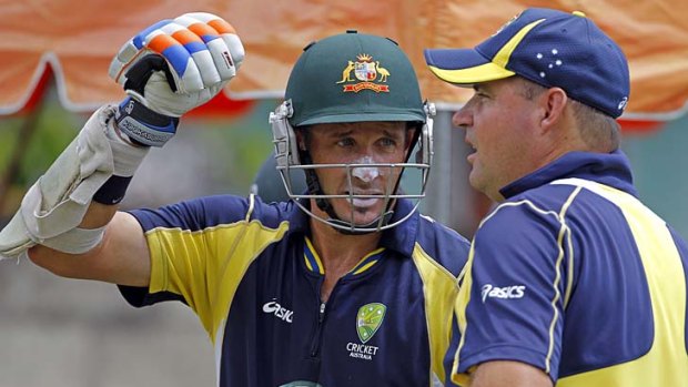 Australia's Mike Hussey, left, speaks to his coach Mickey Arthur.