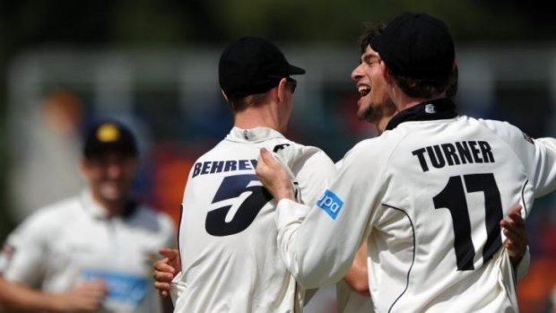 Jason Behrendorff celebrating with Ashton Agar and Ashton Turner after the fall of Smith's wicket.