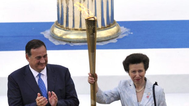 Princess Anne holds aloft the Olympic flame in Athens, Greece.