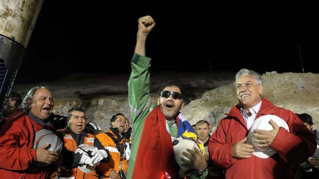 The last miner to be rescued, Luis Urzua, gestures next to Chilean President Sebastian Pinera.