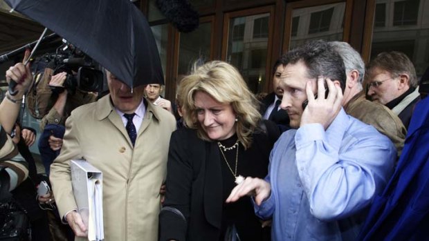 Media circus ... US-based Scientologist Janice Meyer follows her supporters through the gathered scrum after being granted bail.