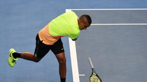 Australia's Nick Kyrgios smashes his racquet on court during his men's singles match against Italy's Andreas Seppi.