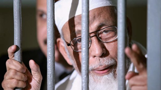 Muslim cleric Abu Bakar Bashir is seen behind bars before his hearing in Jakarta in June 2011