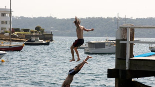Pier pressure...bathers cool off in the harbour yesterday.