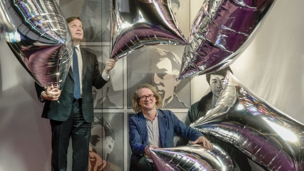 NGV Director Tony Ellwod and curator Max Delaney with Warhol's Silver Clouds.