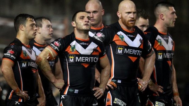 Hard times: Tigers players feel the pain of another heavy defeat.
