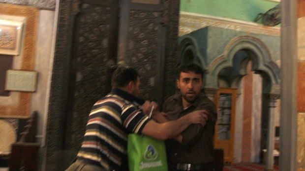 "You are a terrorist" ... a security guard, left, scuffles with a Palestinian man during the visit of Middle East envoy Tony Blair to the Ibrahimi mosque in the West Bank city of Hebron.