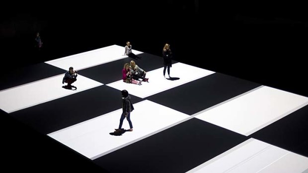 Visitors on a pattern that is projected onto the floor during the of a new work by the Paris-based Japanese artist Ryoji Ikeda in Sydney.