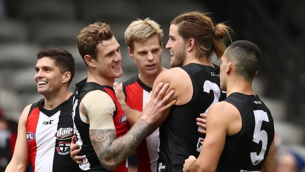 Nick Riewoldt of the Saints is congratulated by Leigh Montagna and Josh Bruce of the Saints after kicking a goal during the round 23 AFL match.