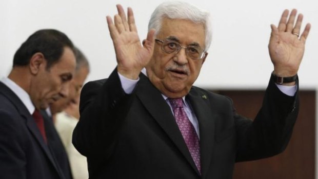 Palestinian President Mahmoud Abbas waves during a swearing-in ceremony of the unity government, in the West Bank city of Ramallah.