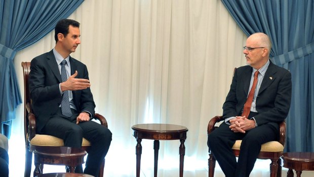 Syrian President Bashar al-Assad meets with Australian academic Tim Anderson in Damascus, in a photo released by Syrian news agency SANA.