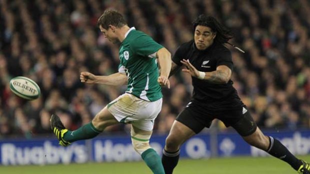 Ireland's Brian O'Driscoll clears the ball from New Zealand's Ma'a Nonu.