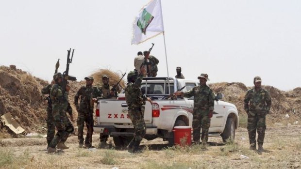 Iraqi security forces and Shiite militiamen chant anti-terrorism slogans after breaking the siege of Amirli following US airstrikes against the Islamic State.
