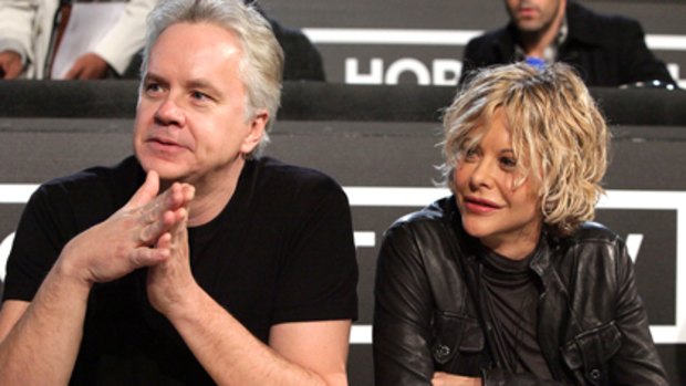 Hooked up? ... Tim Robbins and Meg Ryan work the phones for Haitian earthquake relief.