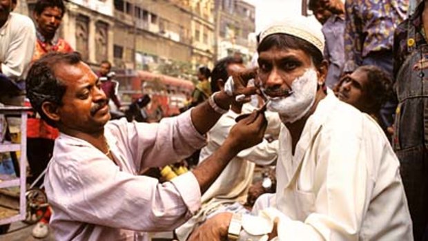 Cutthroat business ... a street barber in action.