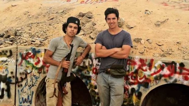 Australian university student Tom Lee (right) with a Libyan rebel fighter at the site where Muammar Gaddafi was dragged out of a drain.