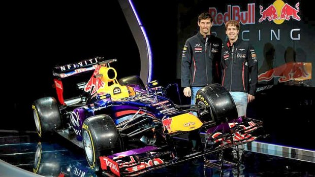 Mark Webber of Australia (L) and Sebastian Vettel of Germany pose along side the new RB9 Infiniti Red Bull car.