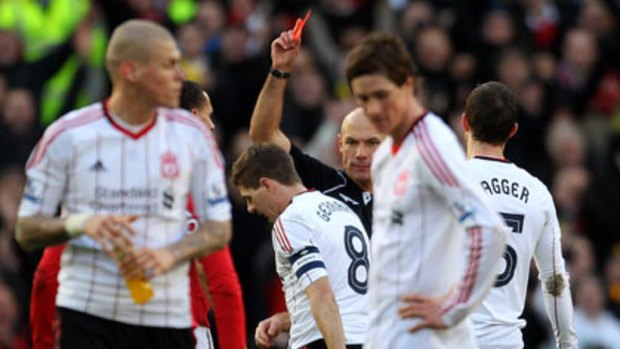 Howard Webb shows Steven Gerrard a red card following his challenge on Michael Carrick.