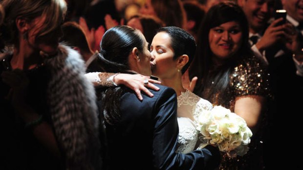 Members of the audience exchange vows during Macklemore, Ryan Lewis, Mary Lambert and Madonna's performance of the song <i>Same Love</i>.