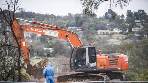 Workers demolish a Mr Fluffy home in the Canberra suburb of Farrer this week.