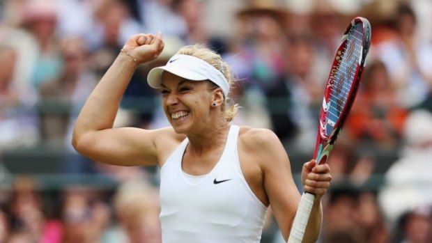 Winners are grinners: Sabine Lisicki is all smiles after defeating Ana Ivanovic in a rain-delayed third-round match.