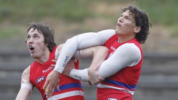 Out of my way: Ayce Cordy and Will Minson battle it out at training.