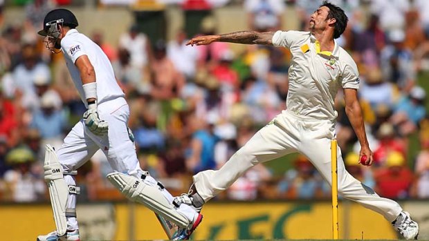 Mitch Johnson storms in to bowl.
