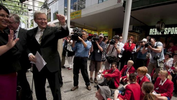 Campaigners &#8230; Kevin Rudd waves cheerily at children during a charity launch in Brisbane yesterday.