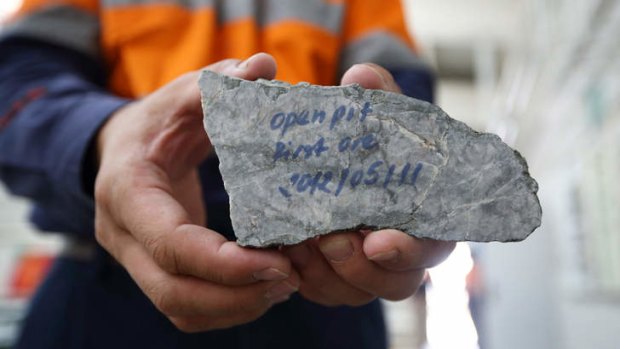 First offering: A worker shows a piece of ore from the Oyu Tolgoi mine in Mongolia.