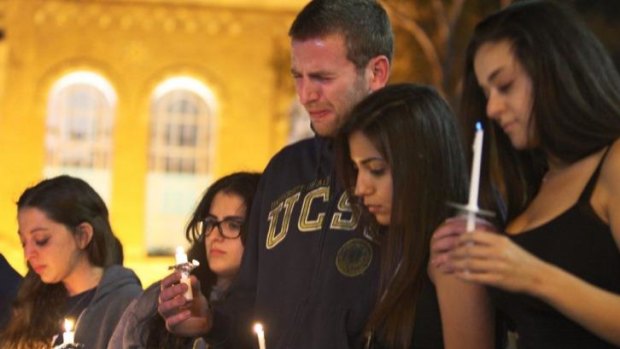 Students of University of California mourn at a candlelight vigil for the victims of the killing rampage.