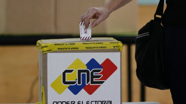 A woman cats her ballot for regional elections in Caracas, Venezuela on Sunday.