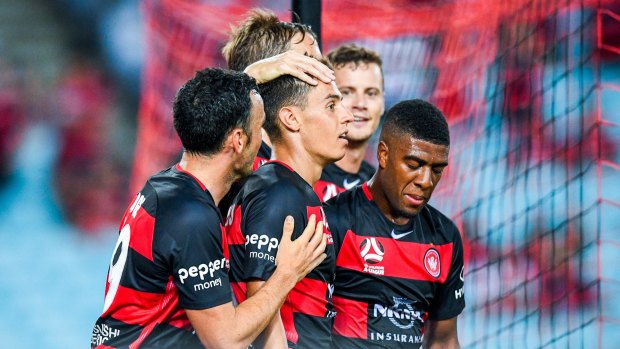 Welcome to the Wanderers: Christopher Ikonomidis is congratulated by his new teammates after turning on something special for his first goal for the club.