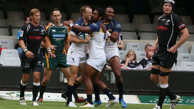 The Brumbies celebrate a try against the Sharks.