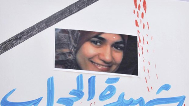 Egyptians flash a poster showing 32-year-old pregnant Egyptian woman Marwa el-Sherbini, top who was stabbed by a German man in a courtroom in eastern Germany last week, during a protest in Cairo, Egypt.