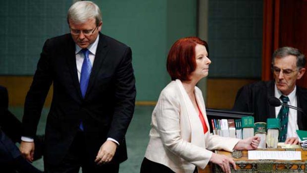 Kevin Rudd passes Julia Gillard during Question Time.