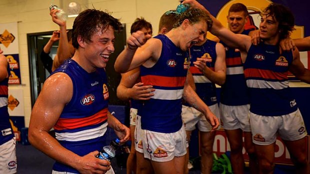 Triumph: The Western Bulldogs, with youngsters Nathan Hrovat and Jack Macrae, celebrate a win over St Kilda last month.