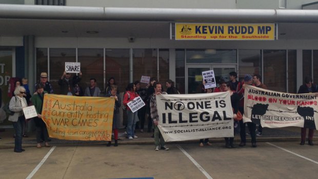 People gather outside Prime Minister Kevin Rudd's Brisbane electorate office to protest the ALP's new asylum seeker policy.