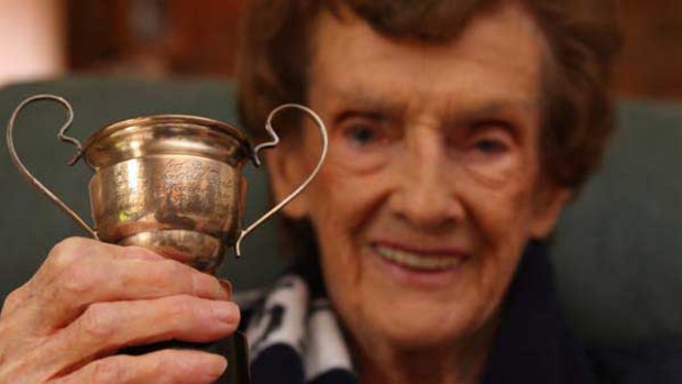 Myra MacKenzie with the cup she received in 1933 when, aged 16, she played in the Carlton ladies team against Richmond.