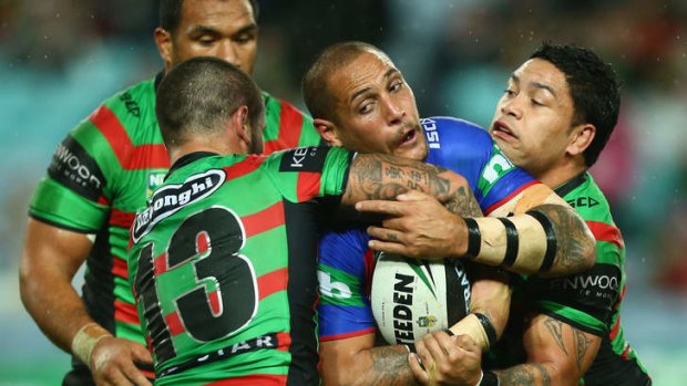 Gotcha: Knights forward Jeremy Smith is tackled during the clash with the South Sydney Rabbitohs at ANZ Stadium.