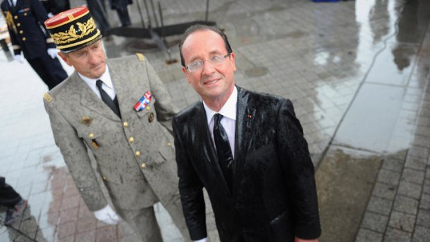 French President Francois Hollande attends a ceremony to the Unknown Soldier at Arc de Triomphe in the pouring rain.  Asked if he was scared of the rain, he replied "I am scared of nothing."