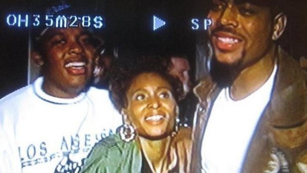 Dee Barnes with Dr Dre (L) and The D.O.C. (R) before Dre assaulted Barnes.