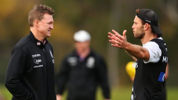 Nathan Buckley talks to Brent Macaffer during a training session.