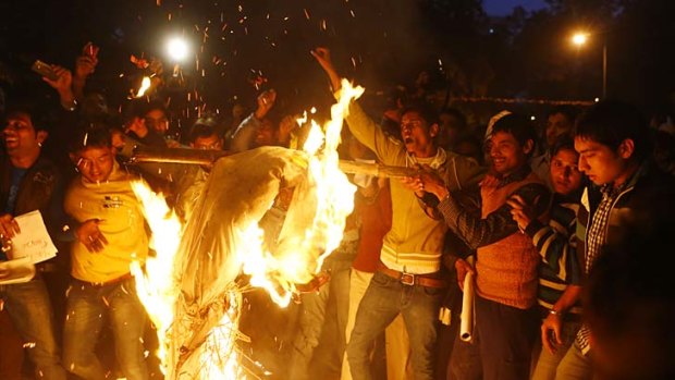 Outpouring &#8230; protesters burn an effigy depicting rapists at a rally in Delhi. The death of a young woman who was raped has triggered anger and grief.