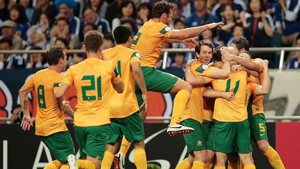 Tommy Oar celebrates his surprise goal with Socceroos teammates on Wednesday.