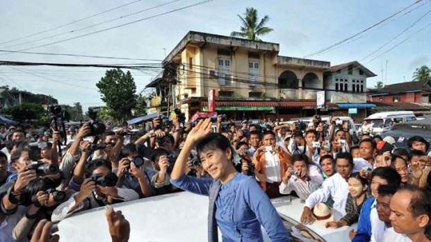 Aung San Suu Kyi greets supporters in Bago, north of Rangoon.